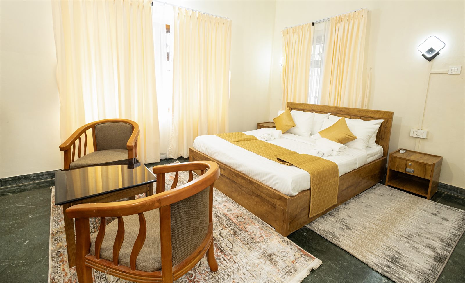 Deluxe room at Bloom Fort Villa with cozy seating and king bed